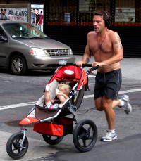 Man running with racing stroller, Park Ave., New York