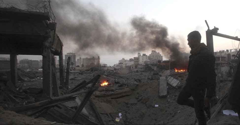 smoking crater which has demolished several buildings to rubble